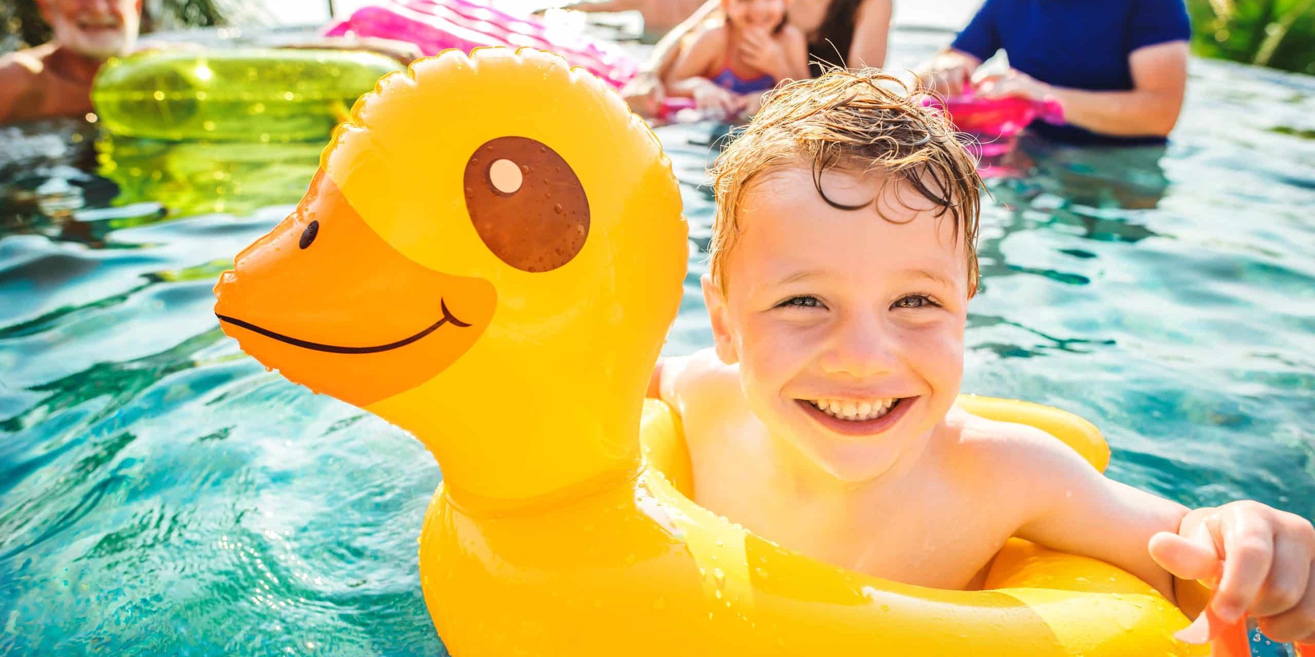 boy floating in a yellow duck